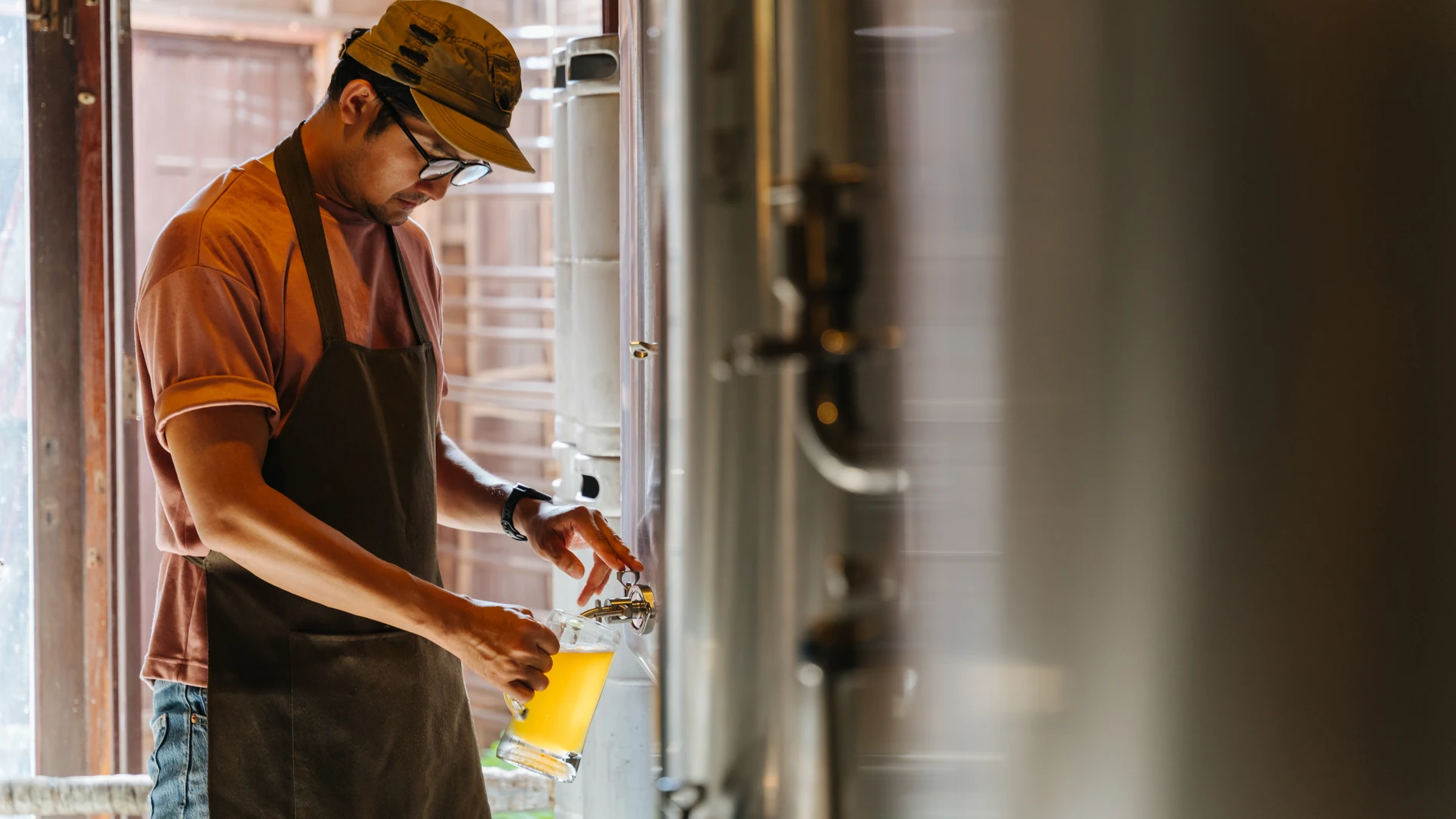 Brewer taking a beer sample