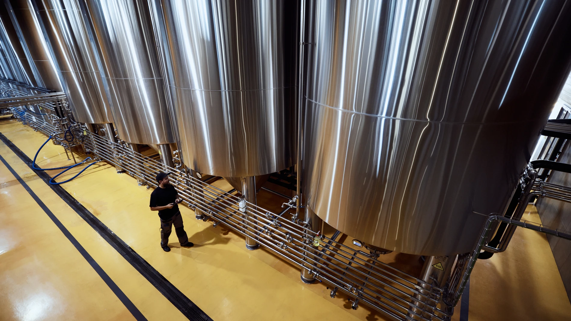 Fermentation tanks seen from above with workers