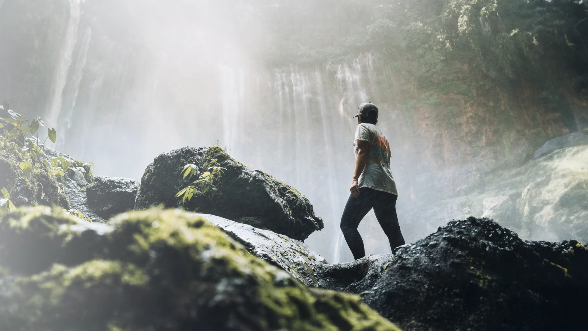 Man_in_the_jungle_looking_at_a_waterfall__