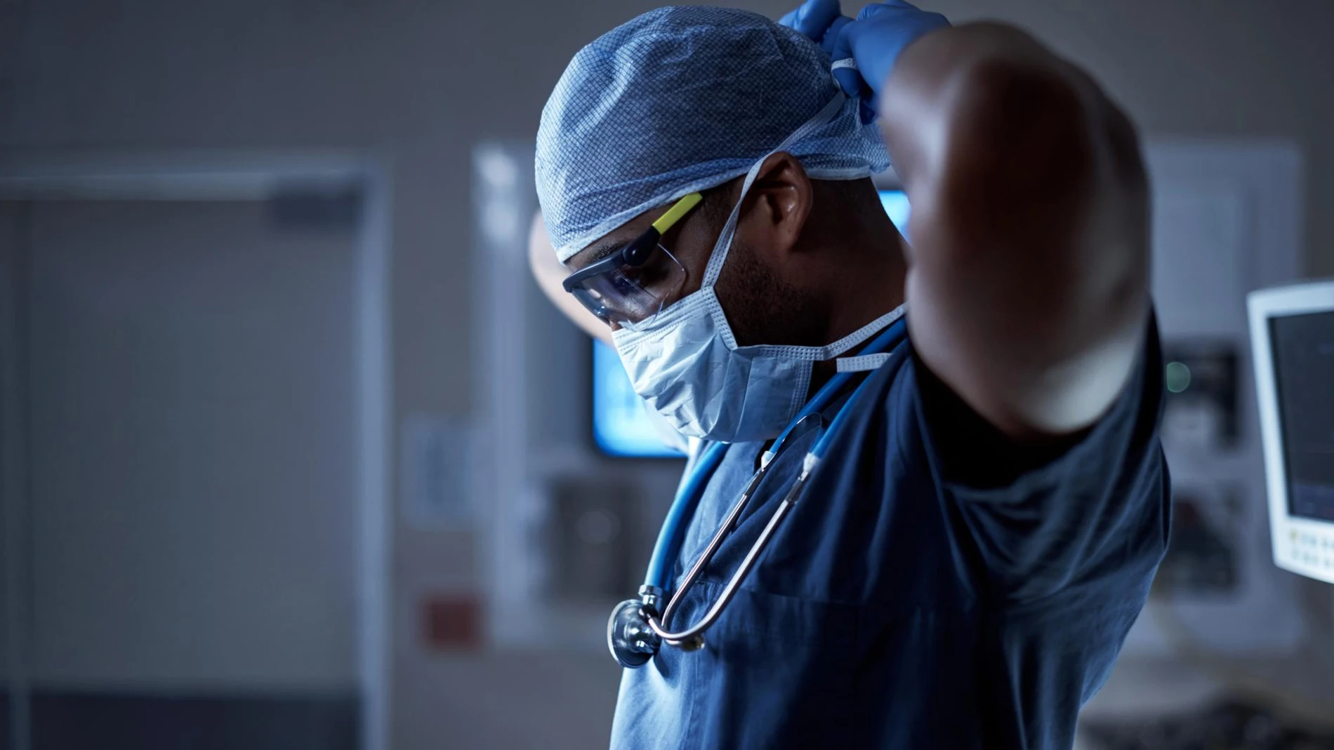 Shot of a surgeon putting on his surgical mask in preparation for a surgery