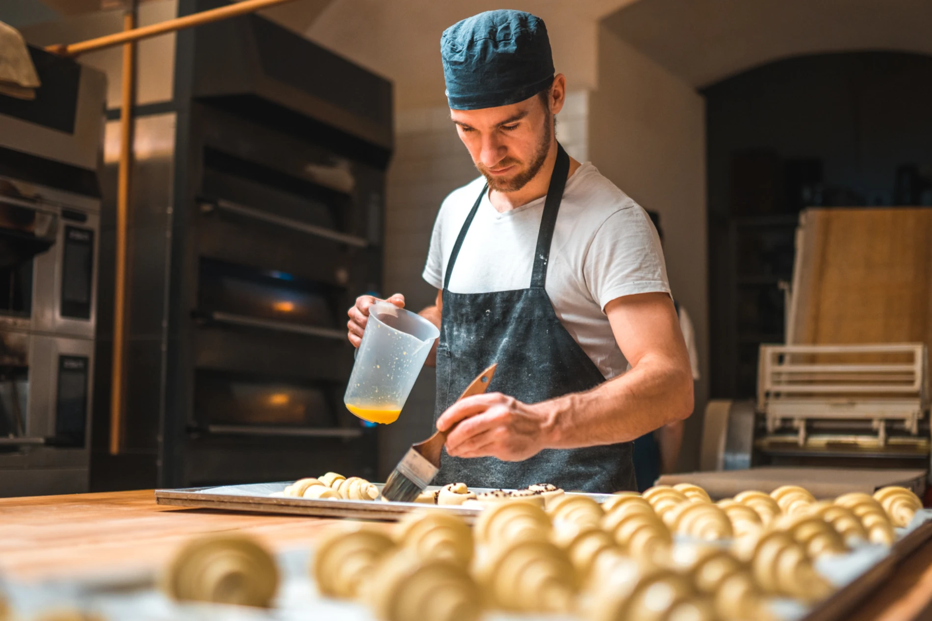 Man buttering croissants 