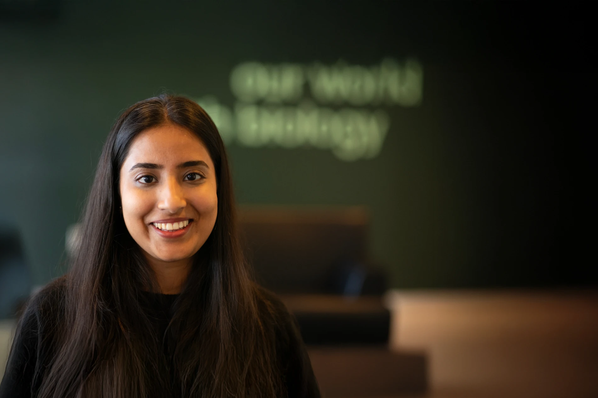 Girl smiling to camera with Novonesis background