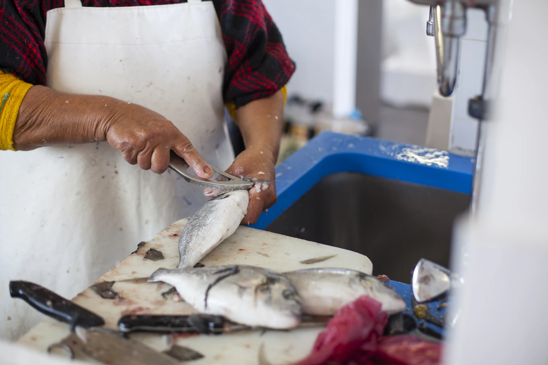 A chef making fish ready for cooking