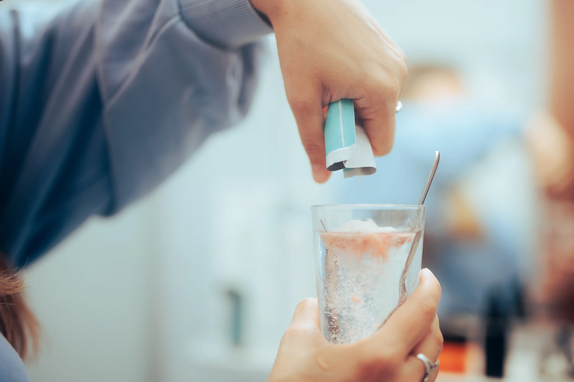 Hand pouring powder in water