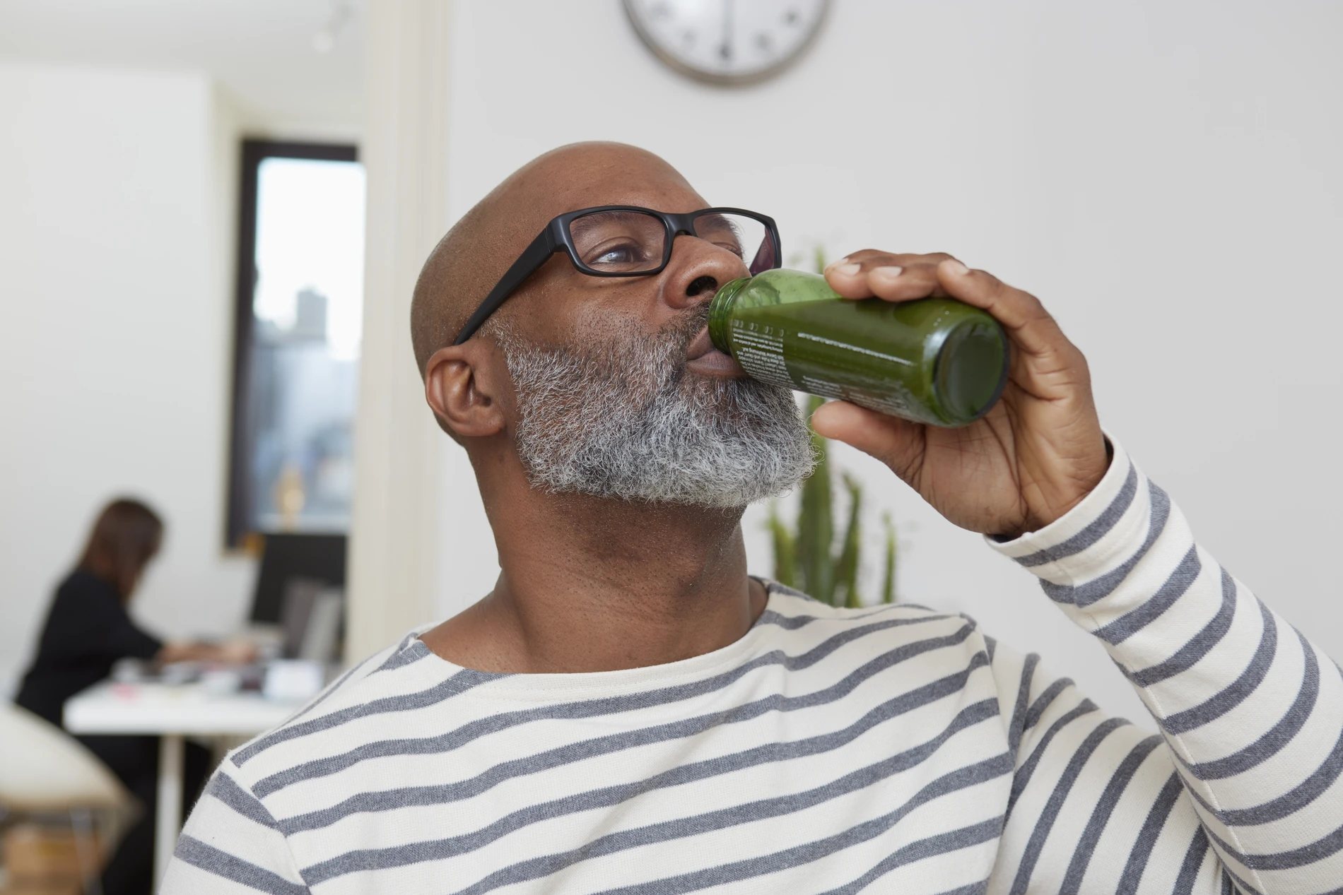Man drinking green juice