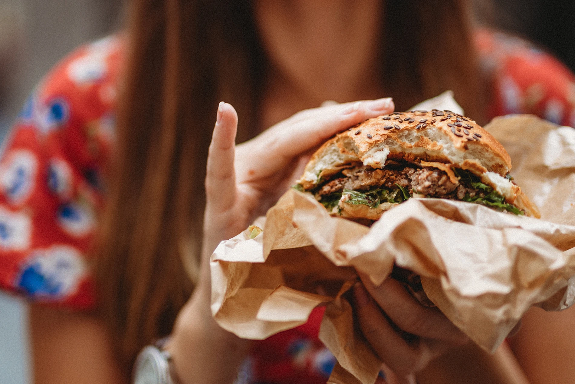 woman holding burger