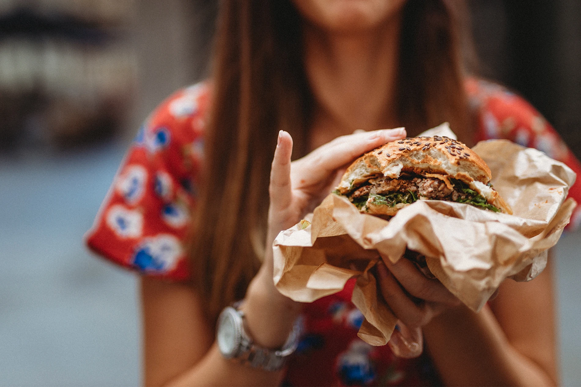 woman holding burger