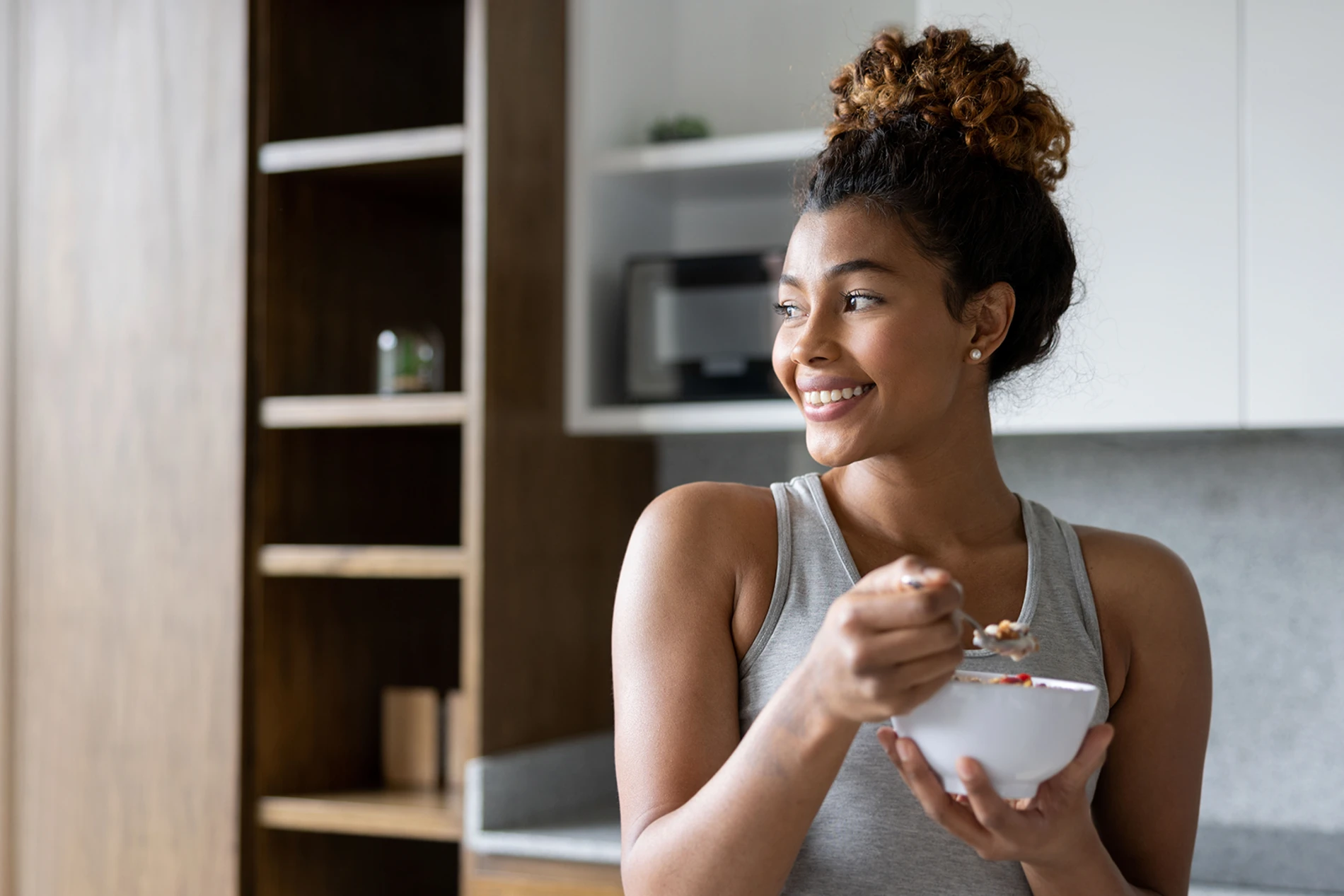 A young lady eating yogurt