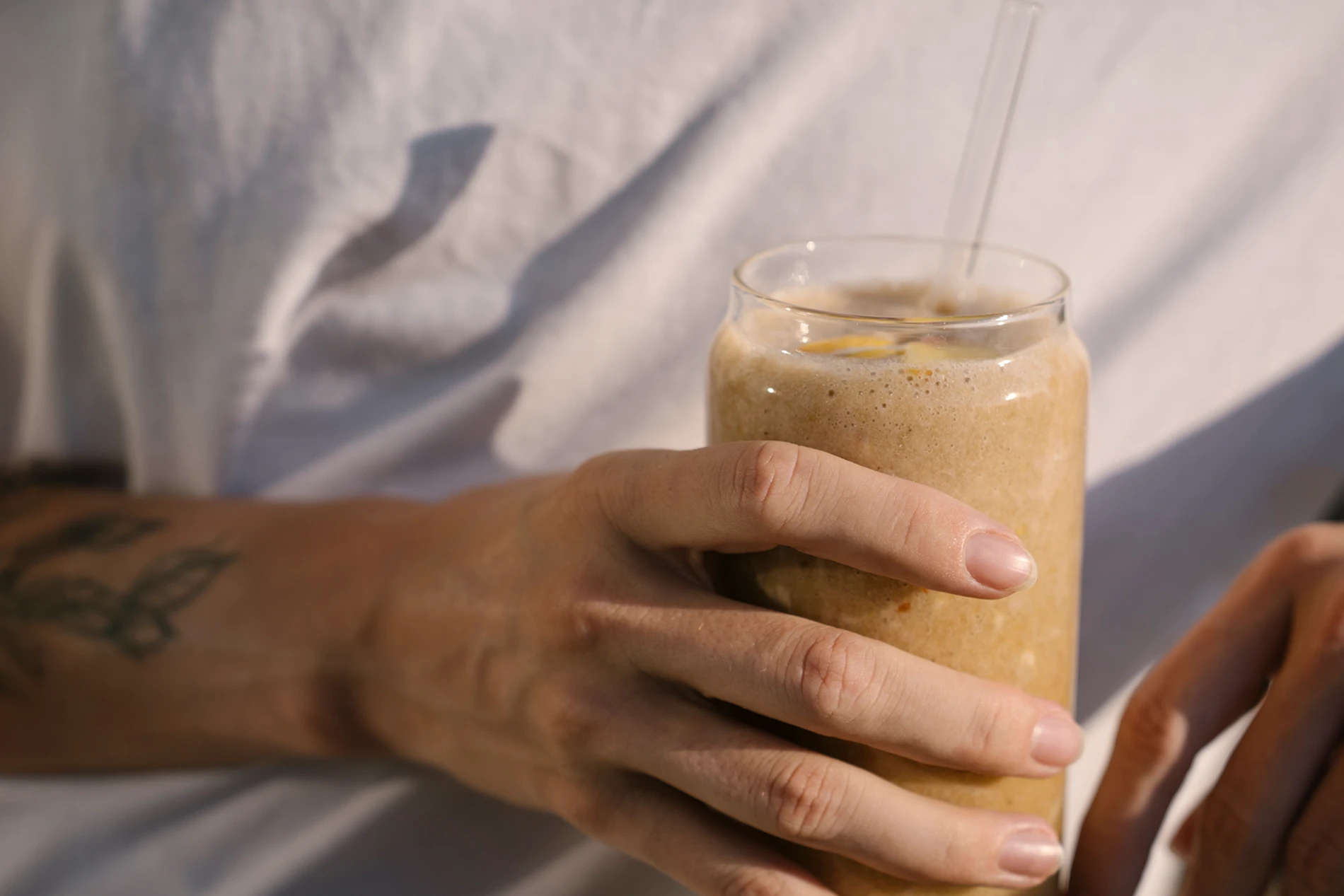 hand holding ice coffee drink