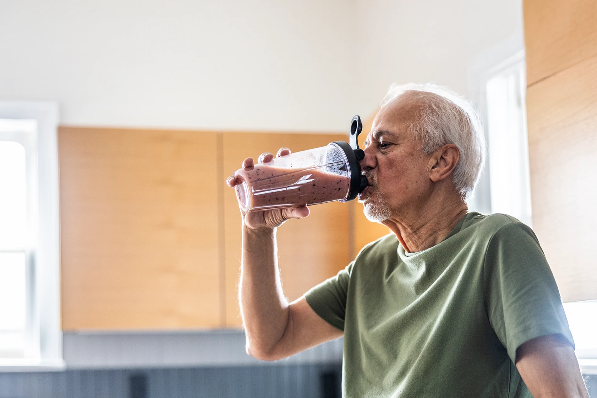 senior man drinking protein smoothie