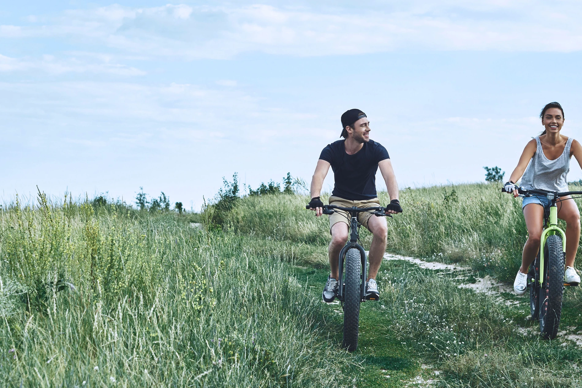 man and woman cycling in countryside