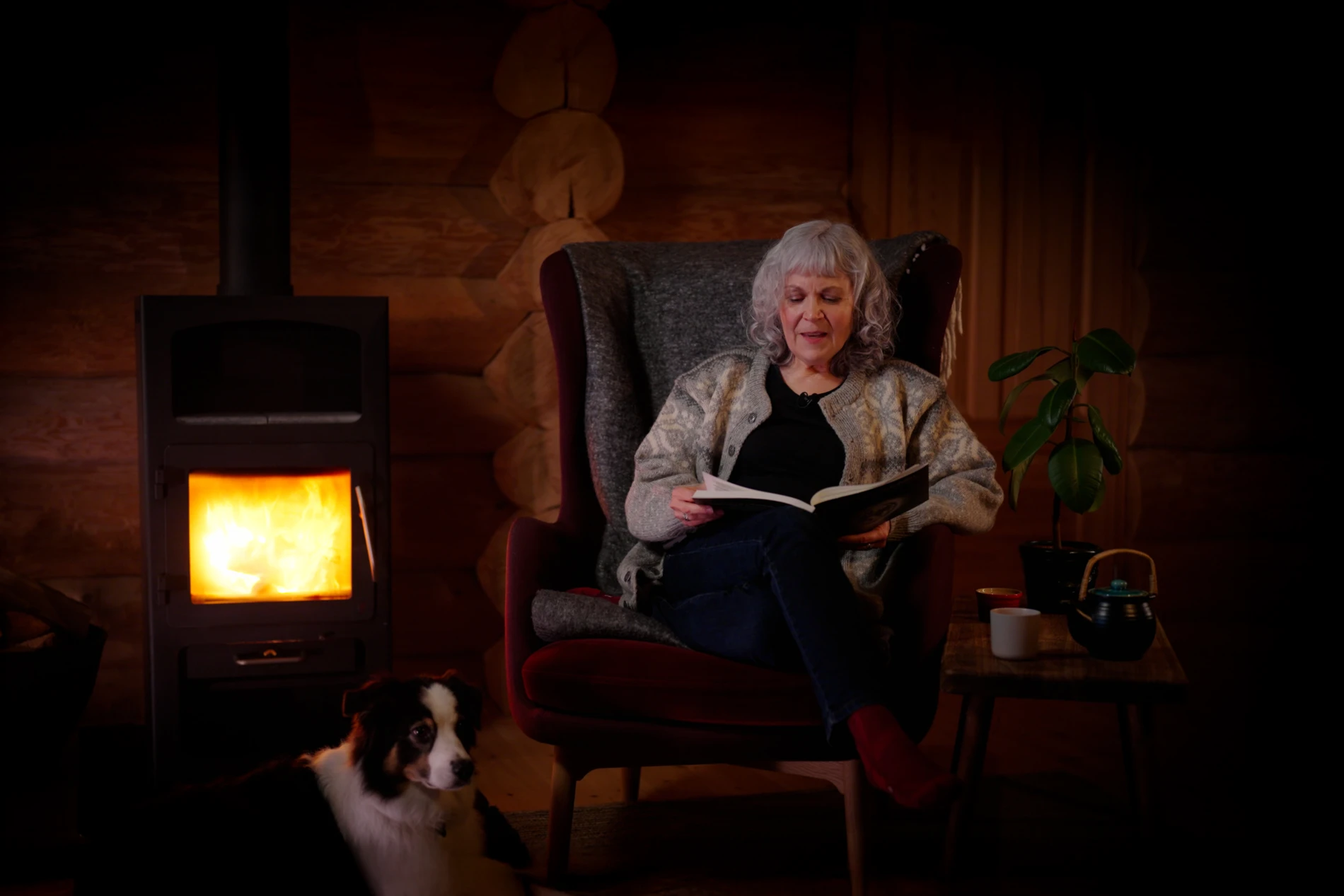 Janet reading the biosolutions bulletin by the fireplace